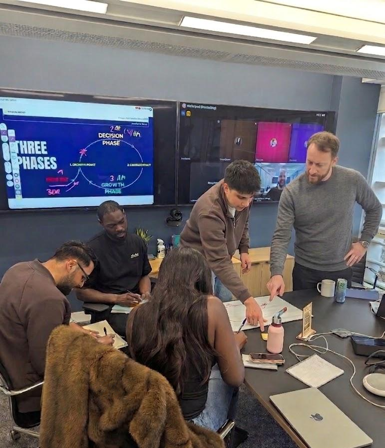 Boris Bedzent facilitating a revenue workshop with a team around a whiteboard